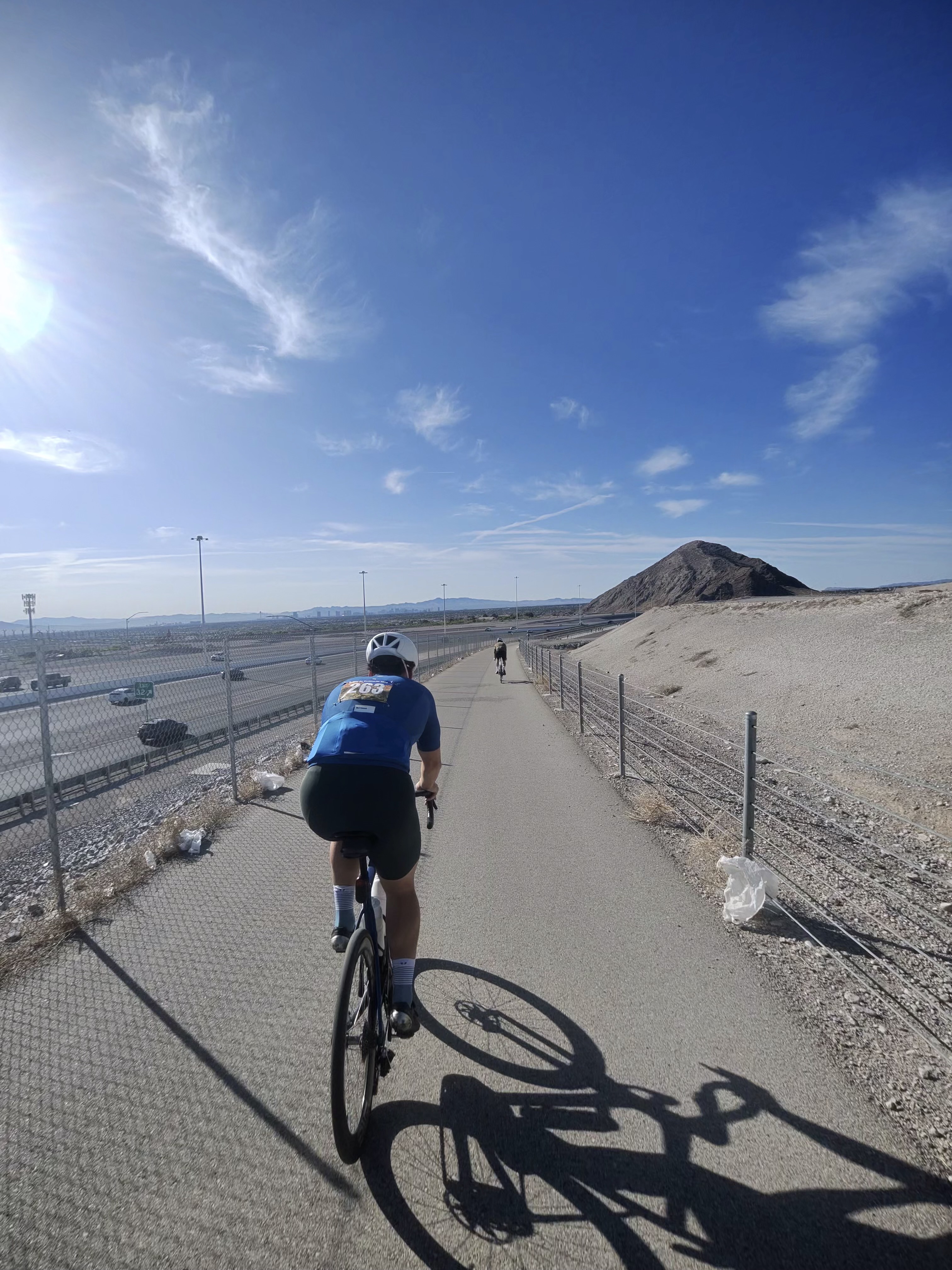 Rider on desert trail with butte