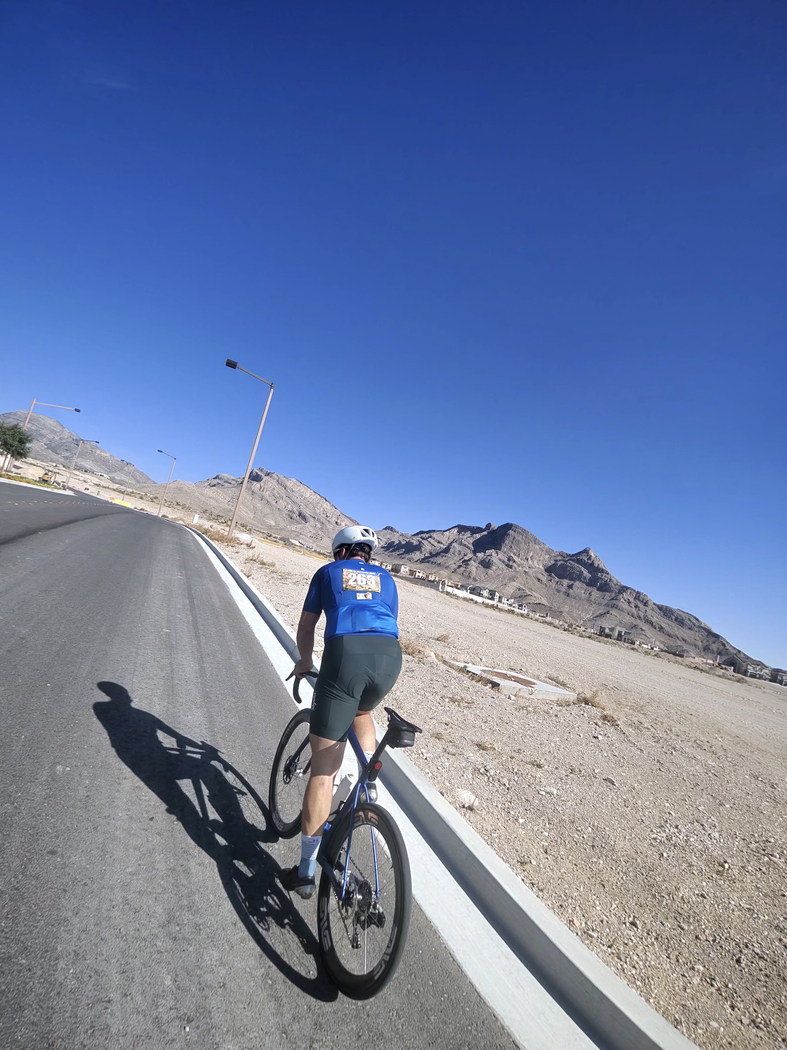 Rider on open desert road with mountains