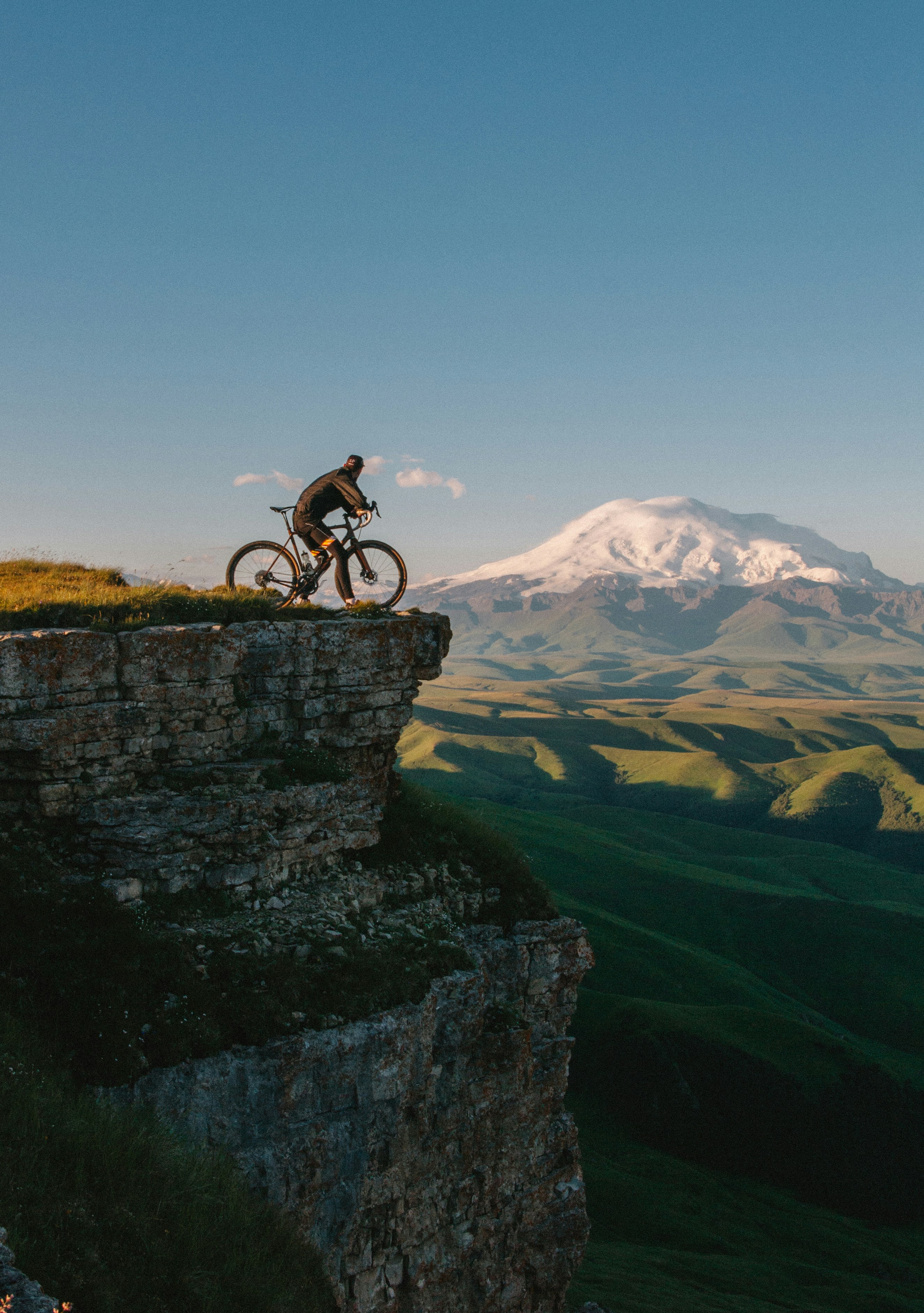 Cyclist overlooking mountain landscape