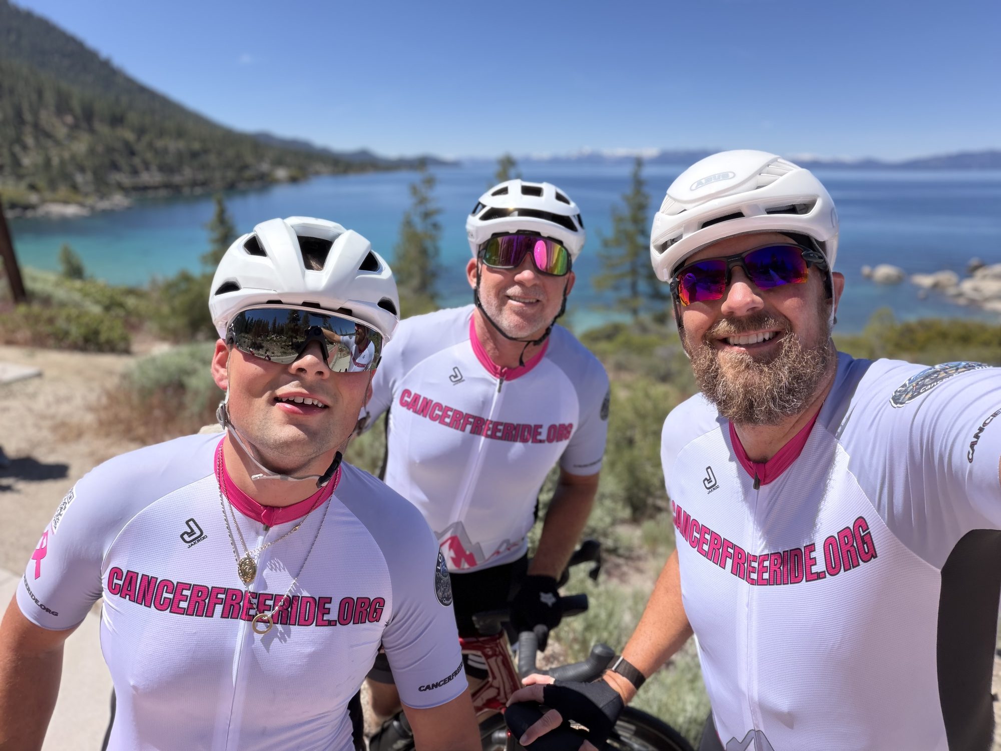 Cancer Free Ride team at Lake Tahoe with turquoise water behind them